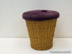 Chic wicker basket with a soft purple lid for elegant and functional storage solutions.