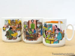 Charming vintage coffee mugs with colorful café scenes, perfect for collectors and coffee enthusiasts.