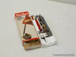 Vintage Weller soldering kit for electronics, featuring a red handle and organized accessories.