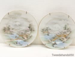 Elegant porcelain plates depicting tranquil landscapes with cherry blossoms, perfect for home décor.