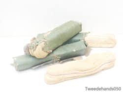 Vintage green and cream textile rolls, perfect for creative projects and crafting nostalgia.