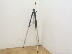 Sleek metal tripod, perfect for stability in minimalist photography and videography setups.