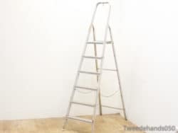 Vintage aluminum step ladder with 7 rungs, perfect for home tasks and stylish decor.