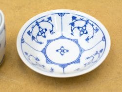 Intricate blue floral porcelain plate, perfect for serving appetizers or as elegant decor.