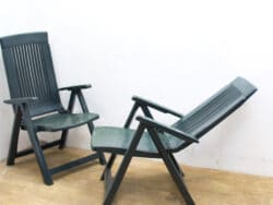 Comfortable dark green outdoor lounge chairs, perfect for relaxing moments on your patio or garden.