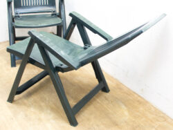 Durable green folding chair for comfortable outdoor lounging and easy storage.