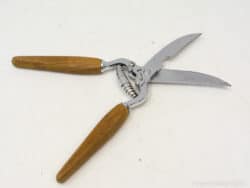 Vintage garden shears with ergonomic wooden handles and stainless steel blades for precise trimming.