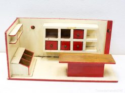 Vintage red and white dollhouse kitchen, perfect for imaginative play and nostalgic charm.