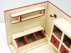 Vintage red and cream miniature kitchen, perfect for imaginative play and nostalgic home decor.