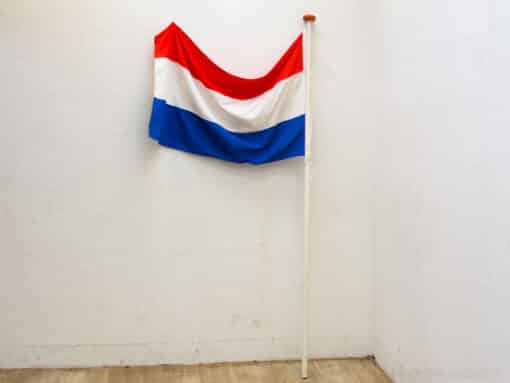 Vibrant Dutch flag in red, white, and blue, showcased against a simple background.