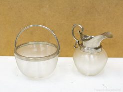 Elegant vintage glass bowl and pitcher set with metal accents for stylish decor and dining.