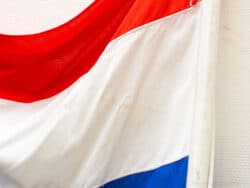 Vintage red, white, and blue flag honoring Dutch heritage, perfect for decor and national pride.