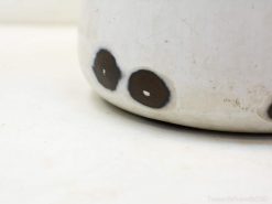 Handcrafted off-white ceramic pot with unique brown circles, perfect for modern decor.