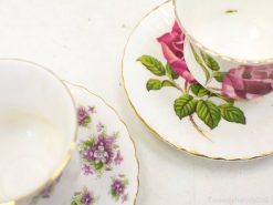 Charming vintage floral teacups with gold trim, perfect for elegant tea settings and decor.