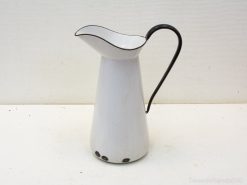 Charming vintage white pitcher with black handle, perfect for decor and daily use.