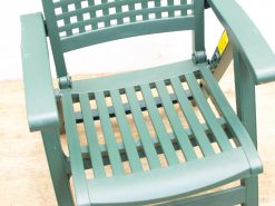 Stylish green outdoor chair with slatted design, perfect for relaxing in gardens or patios.