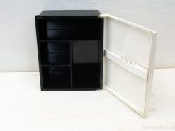 Stylish black and white storage box with compartments for organizing craft and office supplies.