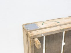 Rustic wooden crate with metal accents, ideal for vintage decor and functional storage.