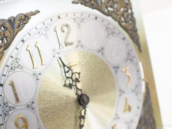 Elegant vintage clock with gold accents and intricate details, perfect for any stylish decor.