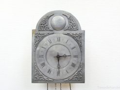 Elegant vintage wall clock with Roman numerals and floral designs, perfect for classic interiors.