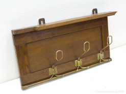 Elegant wooden coat rack with brass hooks and shelf for stylish entryway organization.