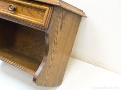 Elegant oak side table with a minimalist drawer and open shelf for stylish storage.