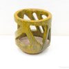 Stylish yellow decorative pot with geometric cutouts, ideal for plants or home decor.