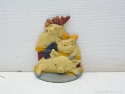 Charming ceramic pigs with colorful bows, ideal for playful home decor and collections.