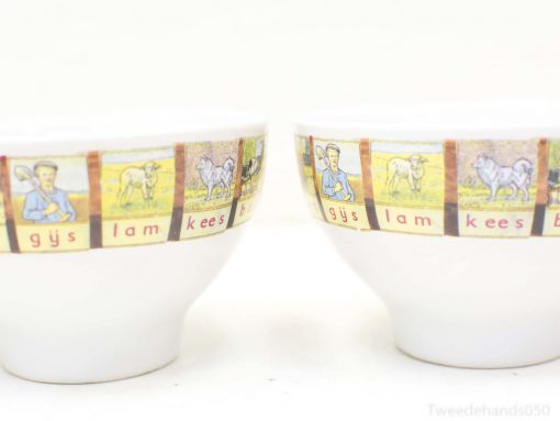 Charming ceramic bowls adorned with vibrant farm illustrations, ideal for rustic decor and functionality.