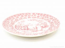 Vintage red and white porcelain plate with floral design, ideal for decor and display.