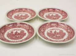 Elegant oval plates showcasing rustic scenes and floral designs, ideal for dining or display.