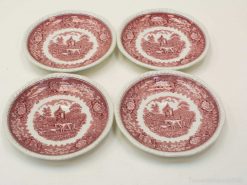 Vintage decorative plates featuring rustic landscapes and floral designs, ideal for display or collection.