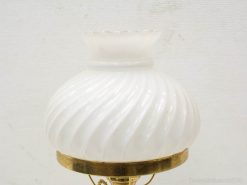 Elegant vintage lamp with white glass shade and brass base, ideal for charming interior decor.