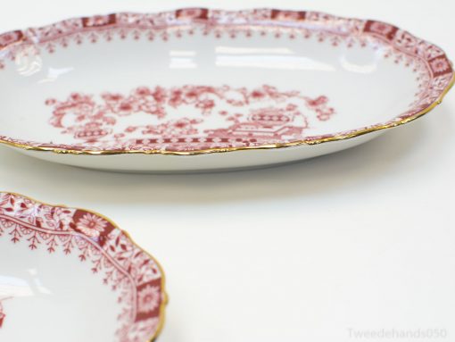 Elegant porcelain serving set with red floral pattern and gold trim, perfect for special occasions.