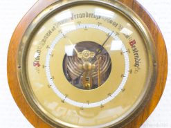 Elegant vintage wooden barometer with glass cover, perfect for classic home decor and weather tracking.