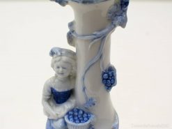 Elegant blue and white porcelain vase featuring a serene girl with grapes, perfect for collectors.