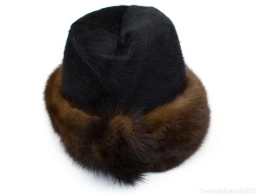 Luxurious black and brown fur cloche hat for stylish warmth in winter fashion.