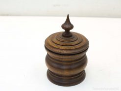 Elegant wooden storage container with a decorative tapered lid and finial for stylish decor.