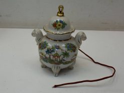 Elegant porcelain jar with floral patterns and lion-head handles, ideal for decor and storage.