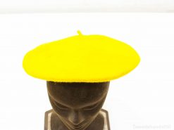 Bright yellow beret on a mannequin, adding playful charm to any fashion ensemble.