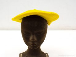 Cheerful yellow felt beret on sleek black mannequin, perfect for bold fashion statements.