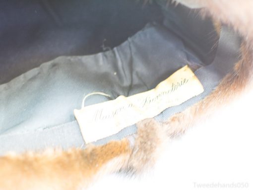 Elegant vintage fur hat with handcrafted Maison de Fourrure label, showcasing timeless luxury and craftsmanship.