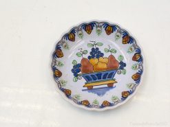 Charming vintage ceramic plate with vibrant fruit basket design for stylish home decor.