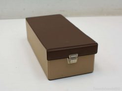 Chic vintage brown and beige storage box with metal latch for organized living spaces.