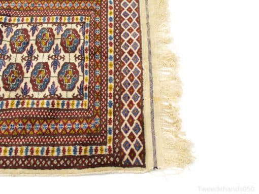 Colorful vintage Persian rug with intricate designs and fringes, enhancing cultural charm and warmth.