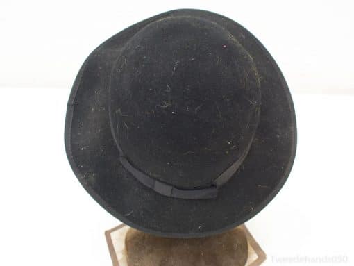 Stylish vintage black fedora with ribbon, showcasing classic elegance and unique character.