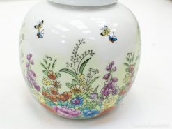 Elegant ceramic jar with vibrant floral patterns and butterflies, ideal for home decor.