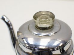 Elegant vintage stainless steel teapot with decorative glass knob for stylish tea service.