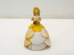 Delicate handcrafted seashell figurine of a woman, perfect for coastal decor and unique gifts.