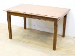 Elegant vintage wooden table with drawer, perfect for dining and workspace versatility.